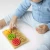 pol_pl_Puzzle-sensoryczne-koleczka-dla-niemowlat-6m-Moms-Care-1383_3.webp